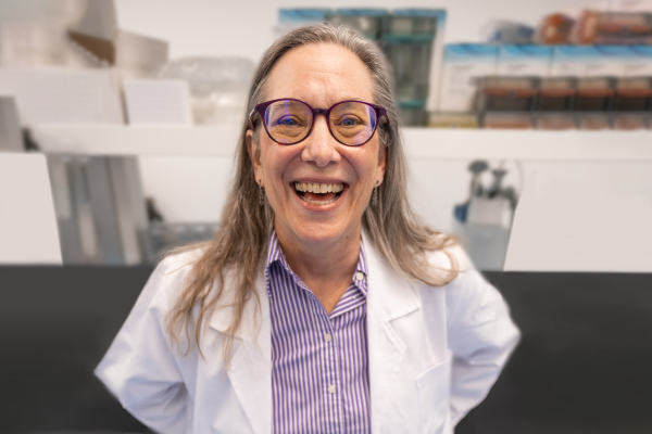 Switch’s Director of Discovery Research Lisa Scherer has big smile wearing lab coat