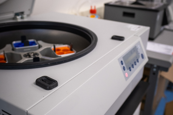 Close-up of centrifuge lab equipment with open top